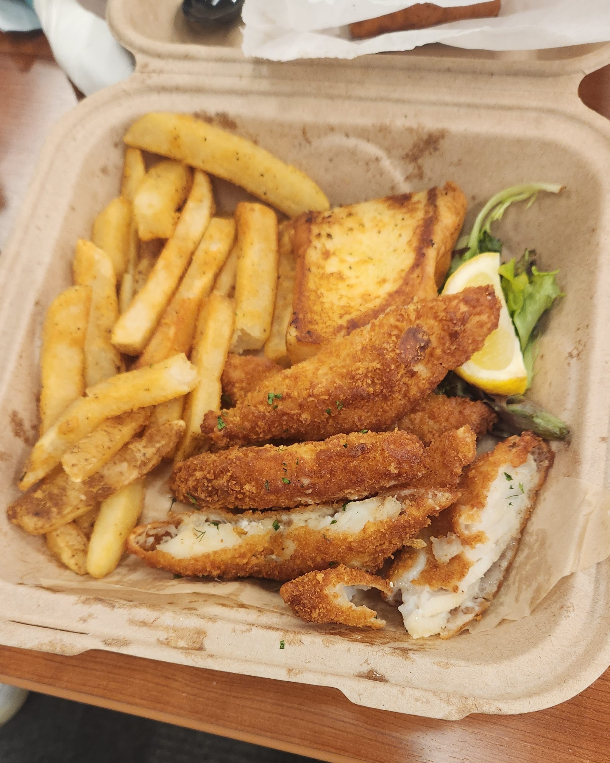 Brown Bag Seafood - Dinner plate of Crispy Cod, French Fries, and Garlic Bread